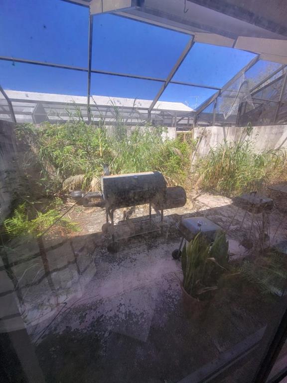 14808 Southwest 124th Court Miami, FL 33186 - Photo 7 of 7 a view of a yard with table and chairs under an umbrella