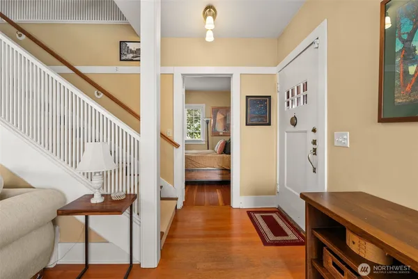 a view of a hallway to a livingroom with furniture