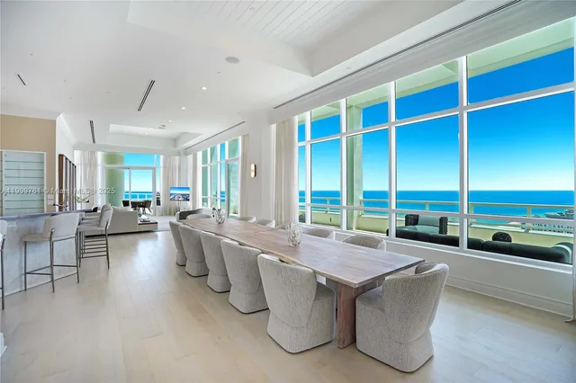 a living room with furniture wooden floor and a large window