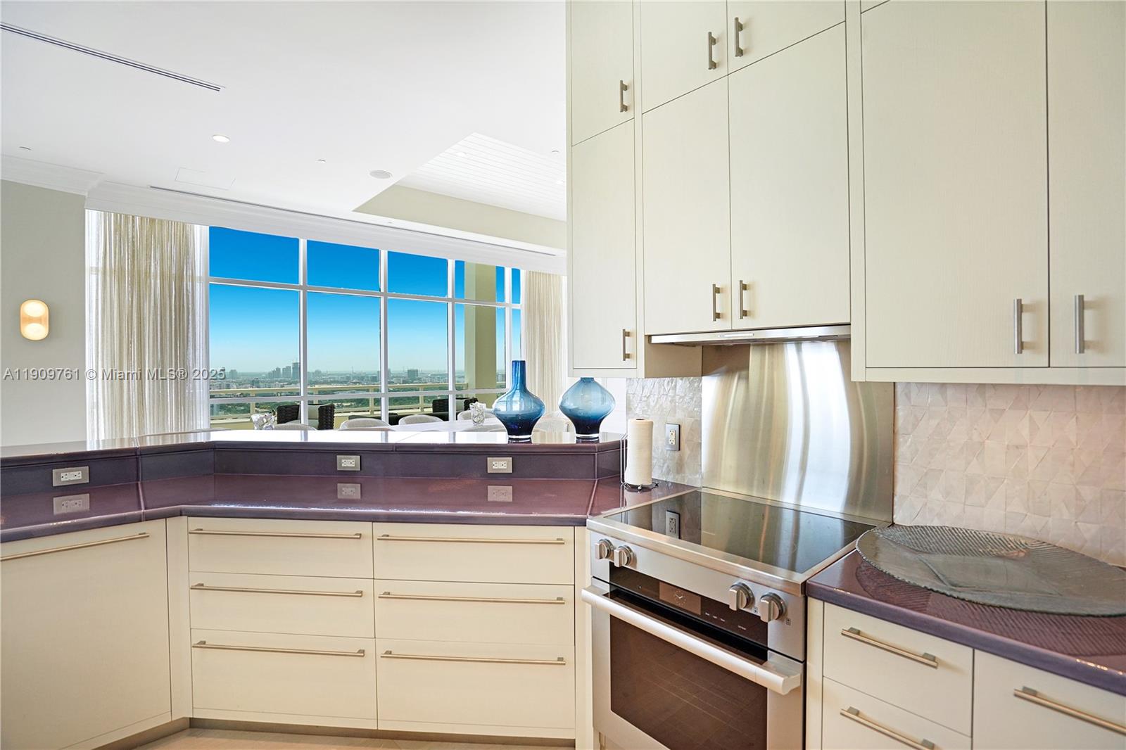 4401 Collins Avenue, Unit PHSOUTH Miami Beach, FL 33140 - Photo 30 of 92 a kitchen with stainless steel appliances white cabinets and a window