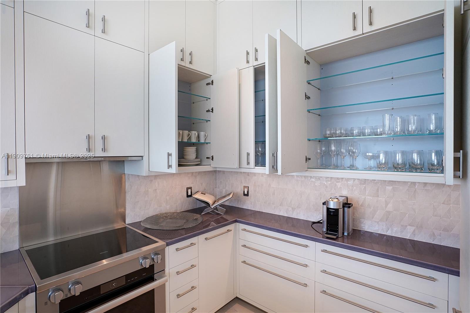 4401 Collins Avenue, Unit PHSOUTH Miami Beach, FL 33140 - Photo 33 of 92 a kitchen with granite countertop a sink stove and cabinets