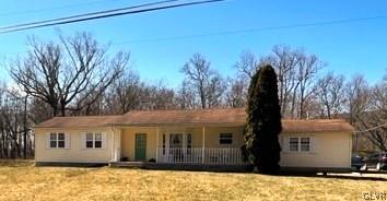 a view of house with a yard