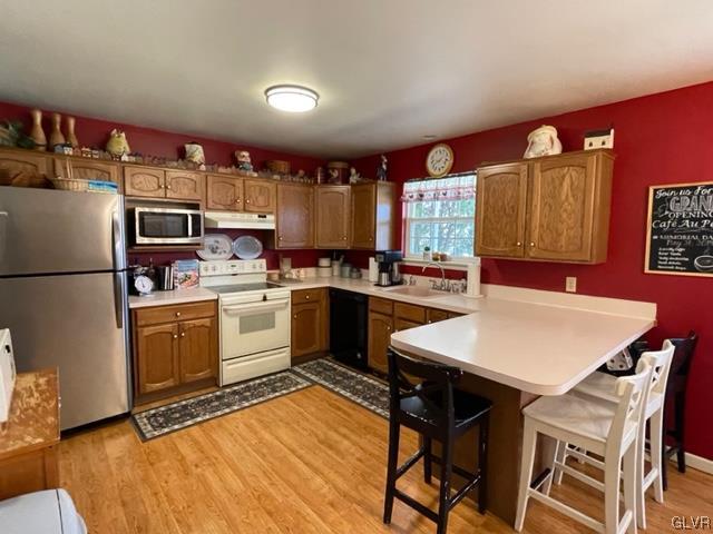 8650 Ulrich Road Germansville, PA 18053 - Photo 11 of 50 a kitchen with a refrigerator a stove top oven a sink and cabinets
