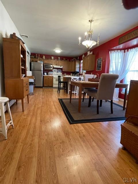 8650 Ulrich Road Germansville, PA 18053 - Photo 8 of 50 a view of a dining room with furniture a chandelier and wooden floor