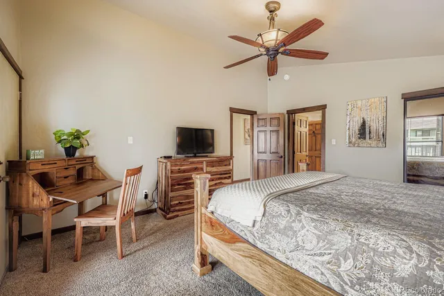 a bedroom with a bed a couch and dresser