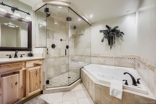 a bathroom with a double vanity sink toilet and shower