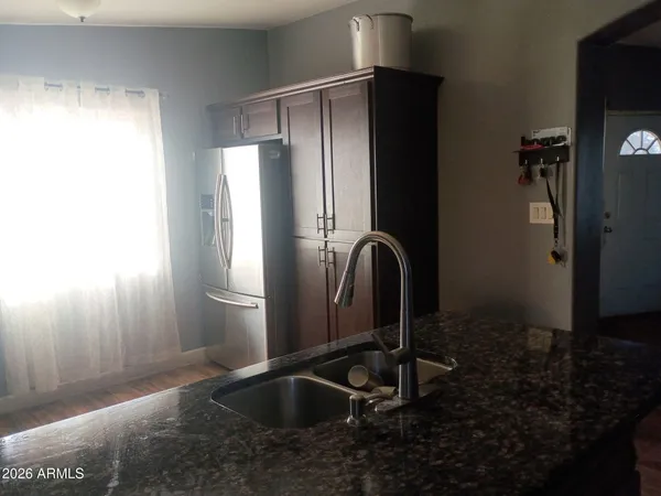 a kitchen with a refrigerator and sink