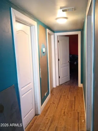 a view of hallway with bathroom and a sink