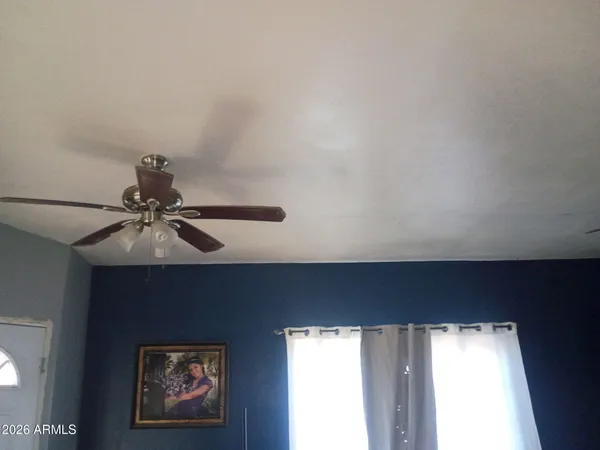 a fan sitting in a room next to a window