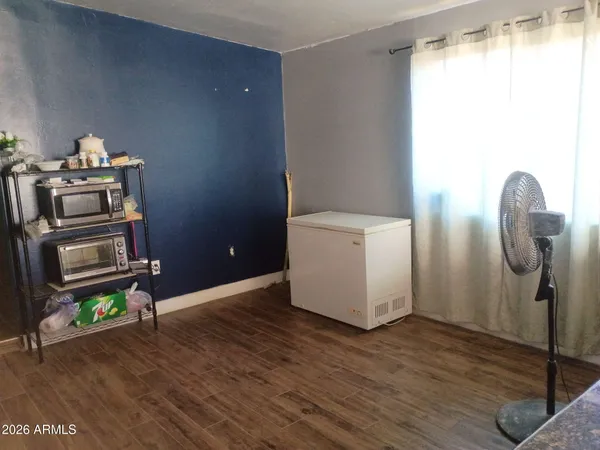 a room with wooden floor and a window