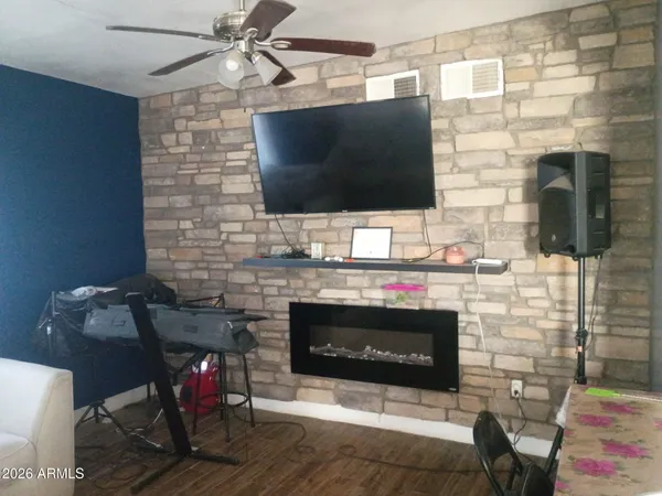 a living room with a fireplace and a flat screen tv
