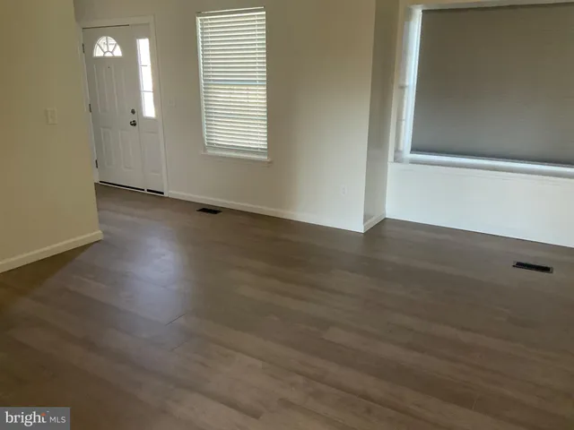 a white toilet sitting next to a bath tub