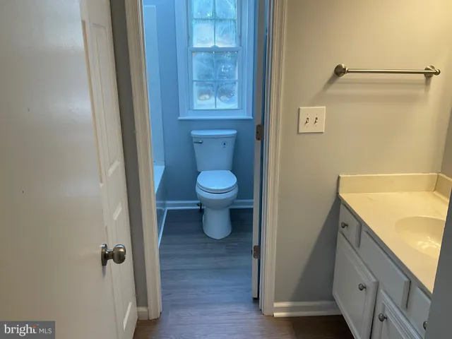 an empty room with wooden floor and entrance