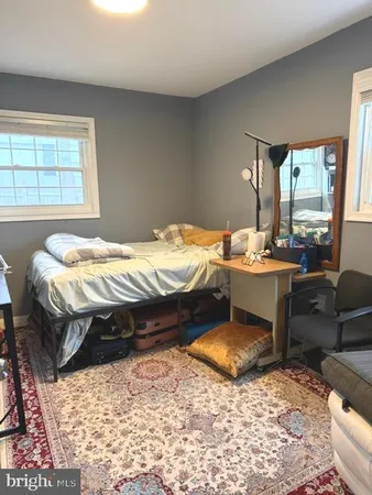 a bed sitting in a bedroom next to a window