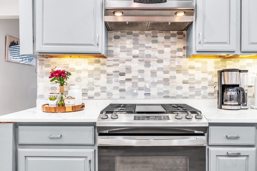 42 D Street Lowell, MA 01851 - Photo 14 of 27 a stove top oven sitting inside of a kitchen