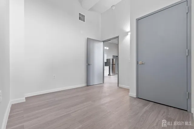 an empty room with windows and closet