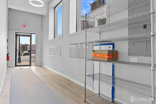 a view of staircase with railing and white walls