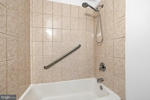 a bathroom with a bath tub and shower