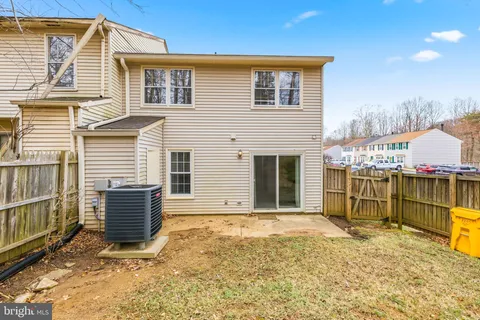 a view of a house with a wooden fence