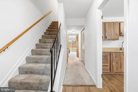 a view of a hallway with wooden floor and entryway