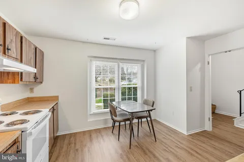 a workspace with wooden floor and a window