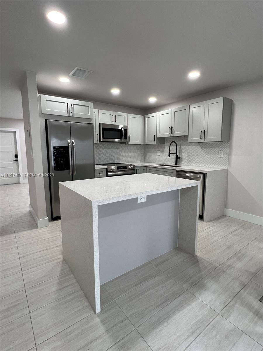 3826 Southwest 107th Avenue, Unit 22 Miami, FL 33165 - Photo 2 of 18 a large kitchen with stainless steel appliances kitchen island a cabinets and a counter space
