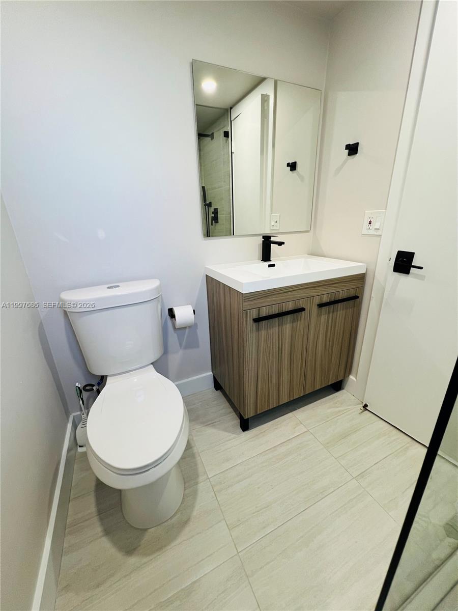 3826 Southwest 107th Avenue, Unit 22 Miami, FL 33165 - Photo 7 of 18 a bathroom with a sink toilet and mirror