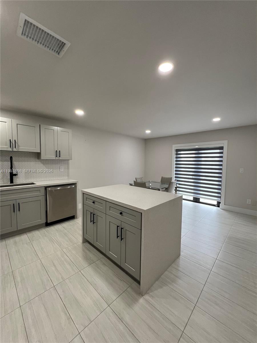 3826 Southwest 107th Avenue, Unit 22 Miami, FL 33165 - Photo 9 of 18 a large white kitchen with a sink a window and stainless steel appliances