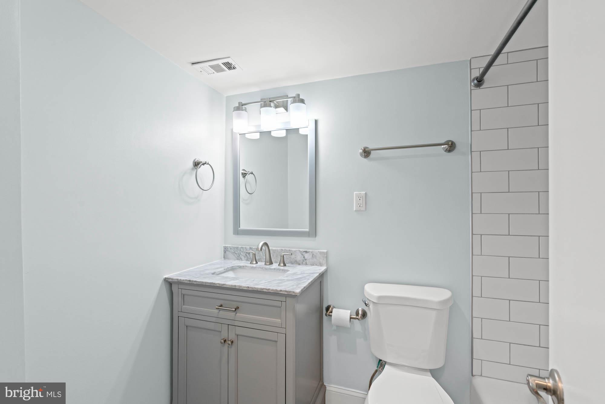 5101 River Road, Unit 1217 Bethesda, MD 20816 - Photo 42 of 61 Renovated white and cheery bath in hall