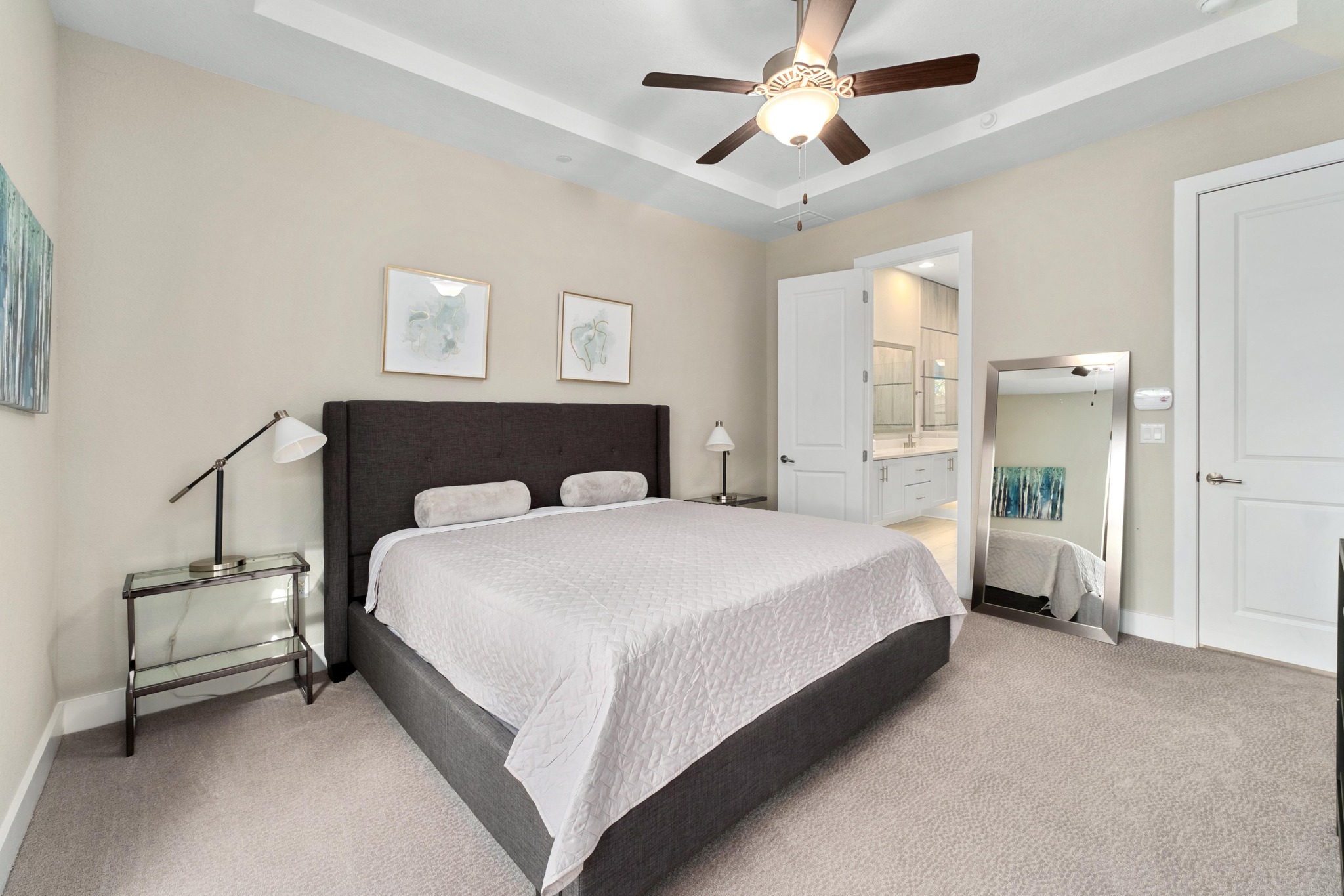 4323 Spicewood Springs Road, Unit 2 Austin, TX 78759 - Photo 11 of 30 Bedroom with a tray ceiling, light carpet, ceiling fan, and connected bathroom