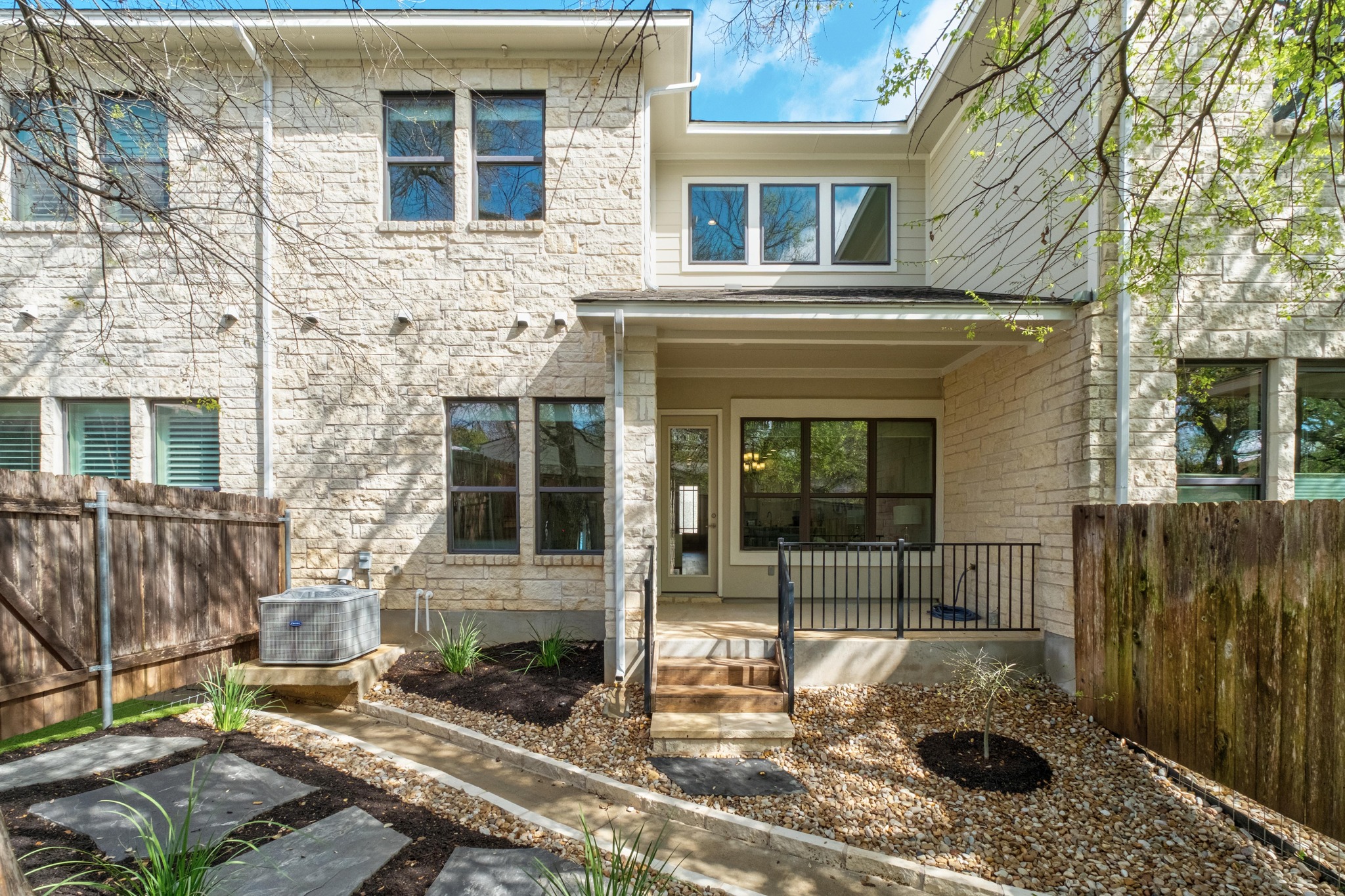 4323 Spicewood Springs Road, Unit 2 Austin, TX 78759 - Photo 25 of 30 Rear view of house with stone siding and covered porch