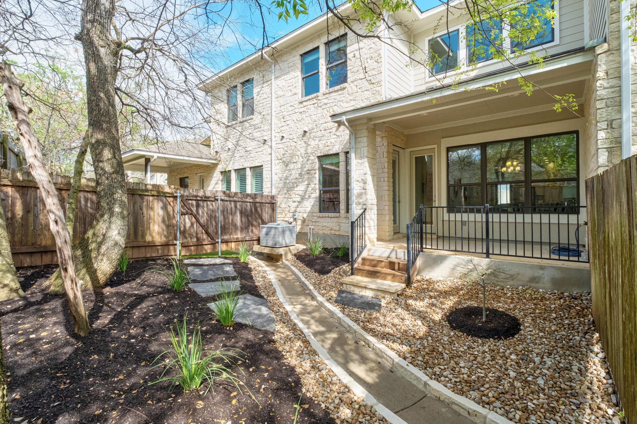 4323 Spicewood Springs Road, Unit 2 Austin, TX 78759 - Photo 26 of 30 Back of property with stone siding and a patio