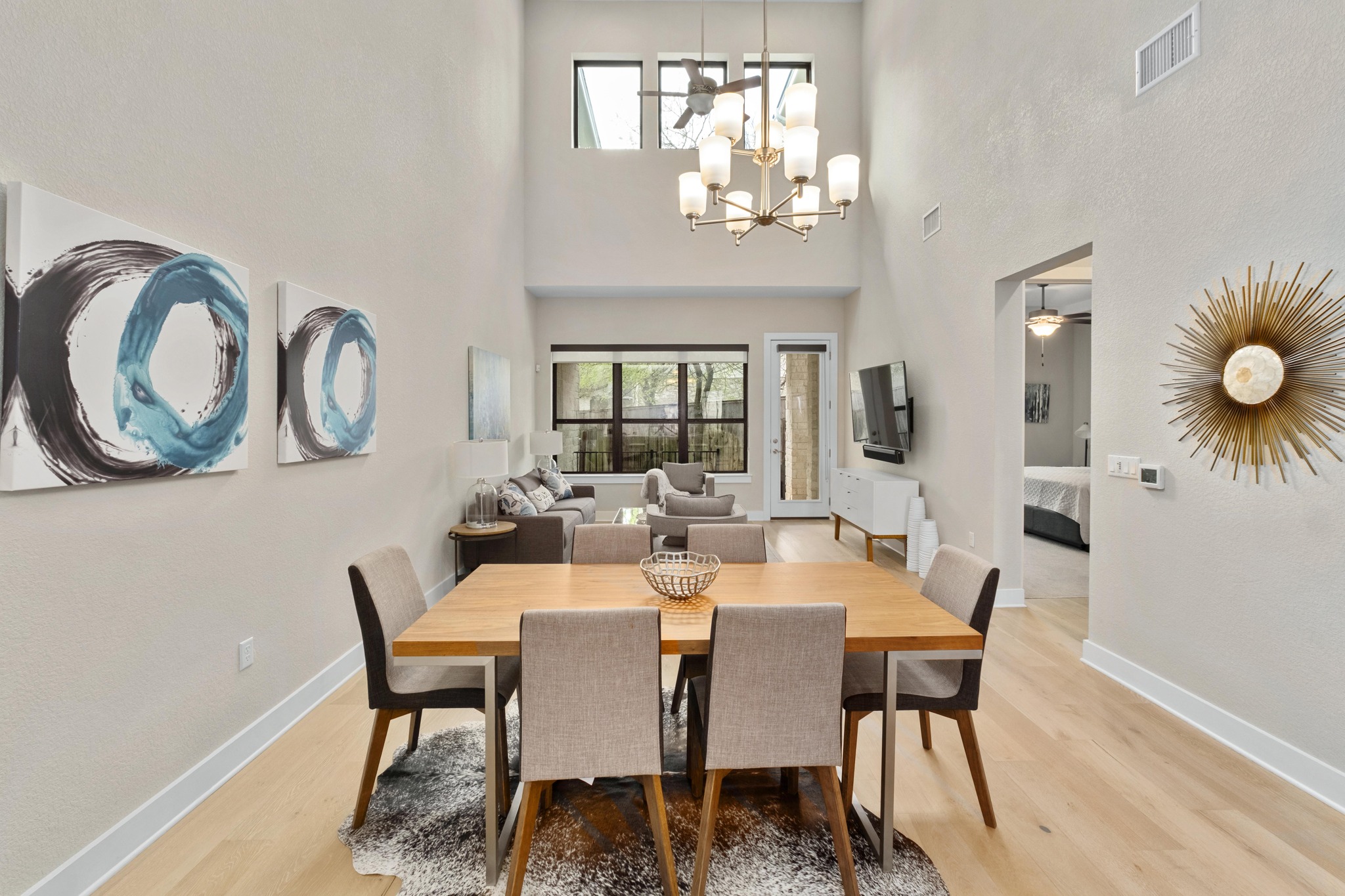 4323 Spicewood Springs Road, Unit 2 Austin, TX 78759 - Photo 9 of 30 Dining room featuring light wood-type flooring, a chandelier, and a high ceiling