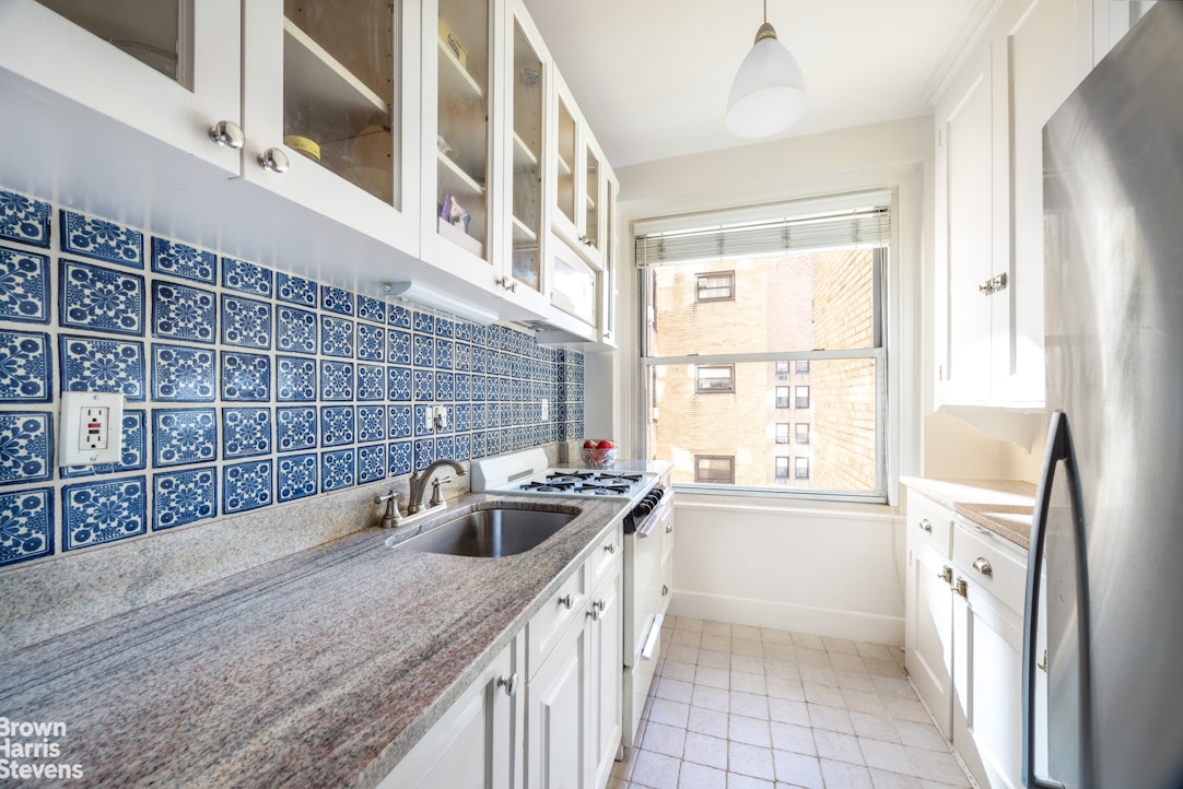 315 East 68th Street, Unit 13F Manhattan, NY 10065 - Photo 5 of 16 a kitchen with a sink a counter top space and a window