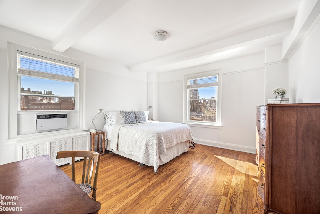 315 East 68th Street, Unit 13F Manhattan, NY 10065 - Photo 6 of 16 a bedroom with a bed and wooden floor