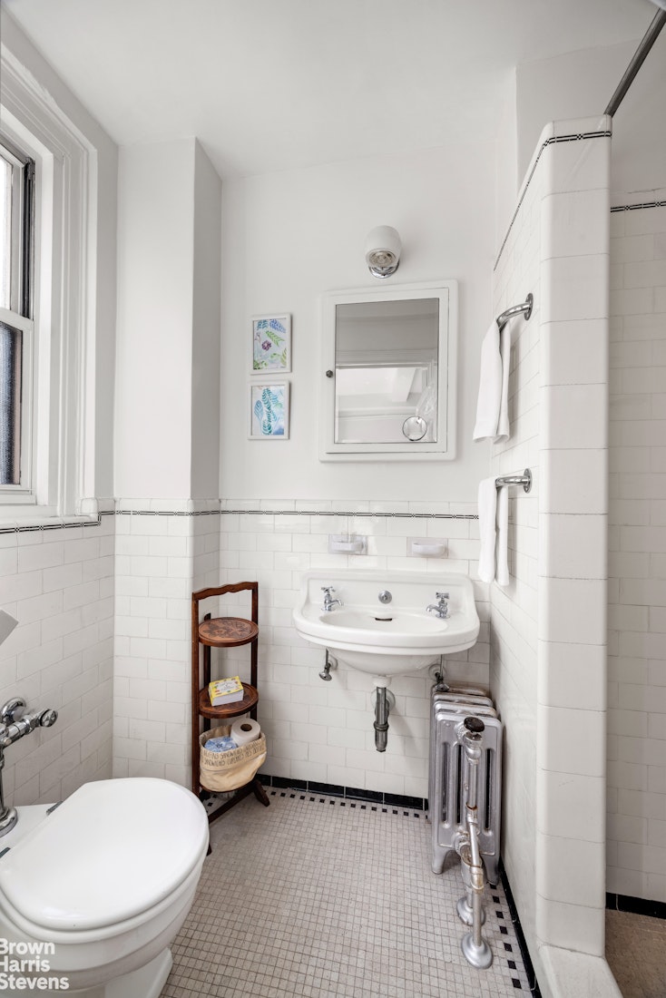 315 East 68th Street, Unit 13F Manhattan, NY 10065 - Photo 9 of 16 a bathroom with a sink toilet and mirror