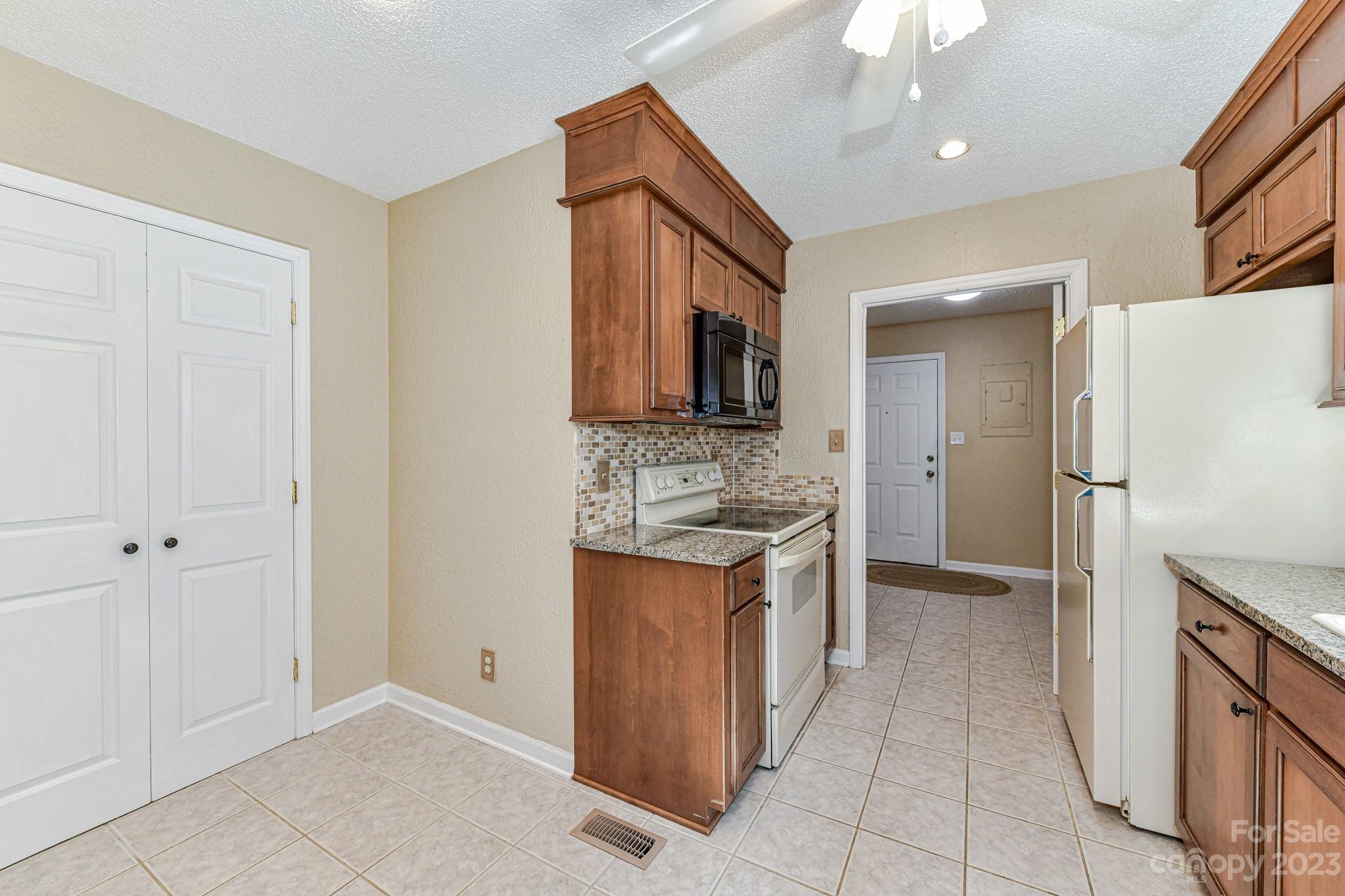4690 Davidson Road Davidson, NC 28036 - Photo 11 of 29 a kitchen with stainless steel appliances granite countertop a stove and a refrigerator