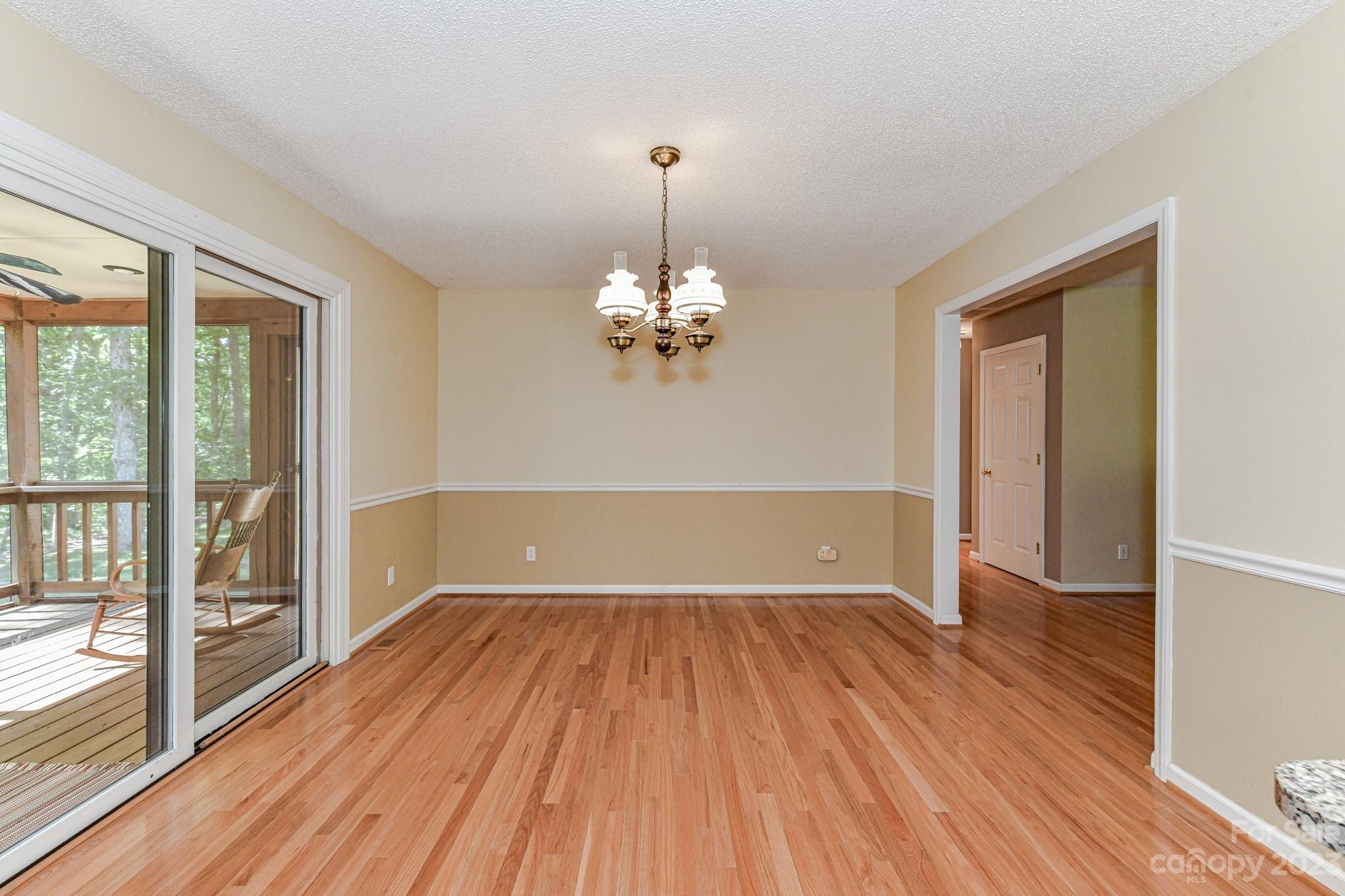 4690 Davidson Road Davidson, NC 28036 - Photo 14 of 29 a view of a room with wooden floor staircase and a living room