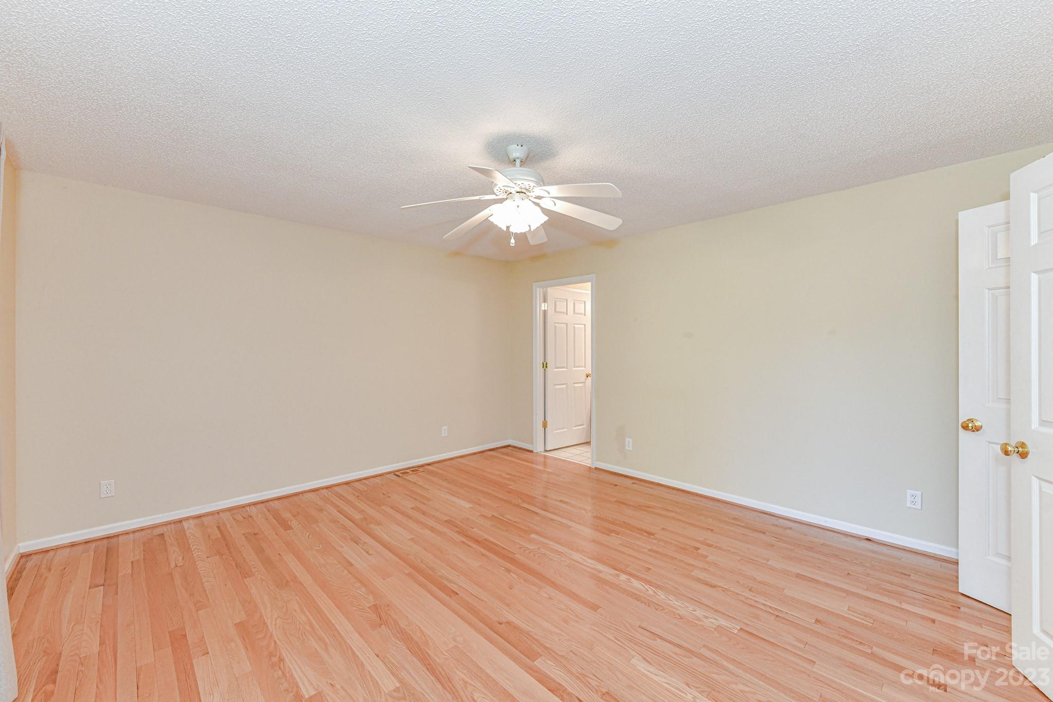 4690 Davidson Road Davidson, NC 28036 - Photo 16 of 29 a view of an empty room with chandelier fan and wooden floor