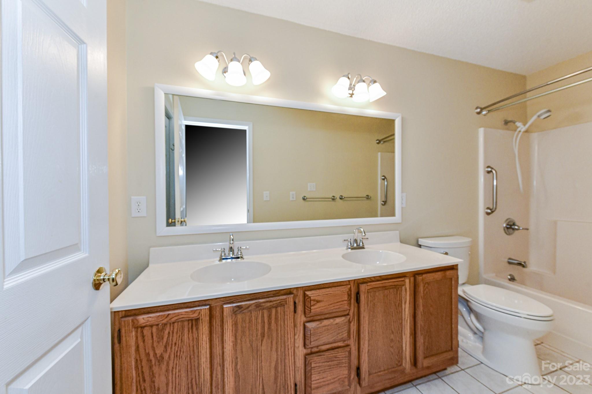 4690 Davidson Road Davidson, NC 28036 - Photo 17 of 29 a bathroom with a sink a toilet and shower
