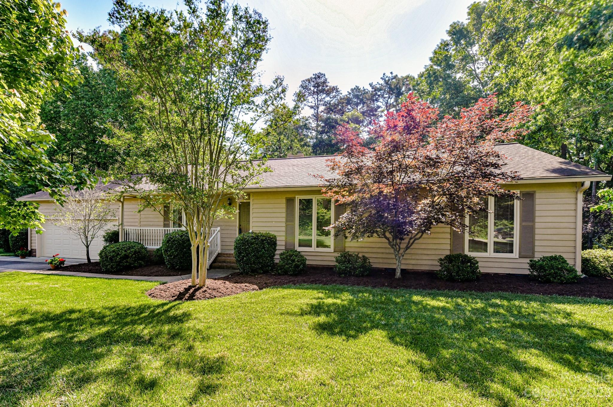 4690 Davidson Road Davidson, NC 28036 - Photo 3 of 29 a front view of a house with a yard and trees