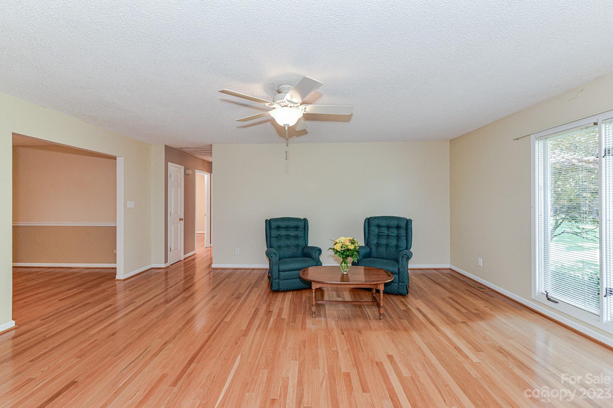 4690 Davidson Road Davidson, NC 28036 - Photo 6 of 29 a living room with furniture and a ceiling fan