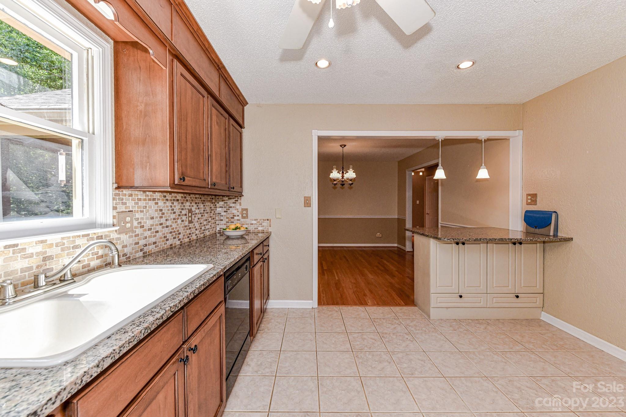 4690 Davidson Road Davidson, NC 28036 - Photo 10 of 29 a large kitchen with granite countertop a sink and cabinets