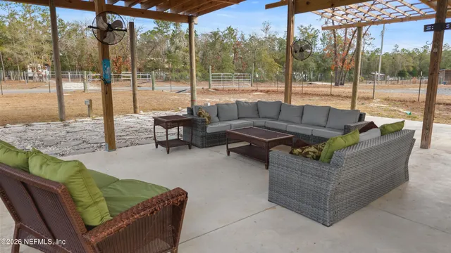 a view of a patio with couches and a table and chairs