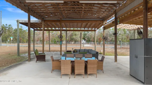 a dining room with furniture and a garden