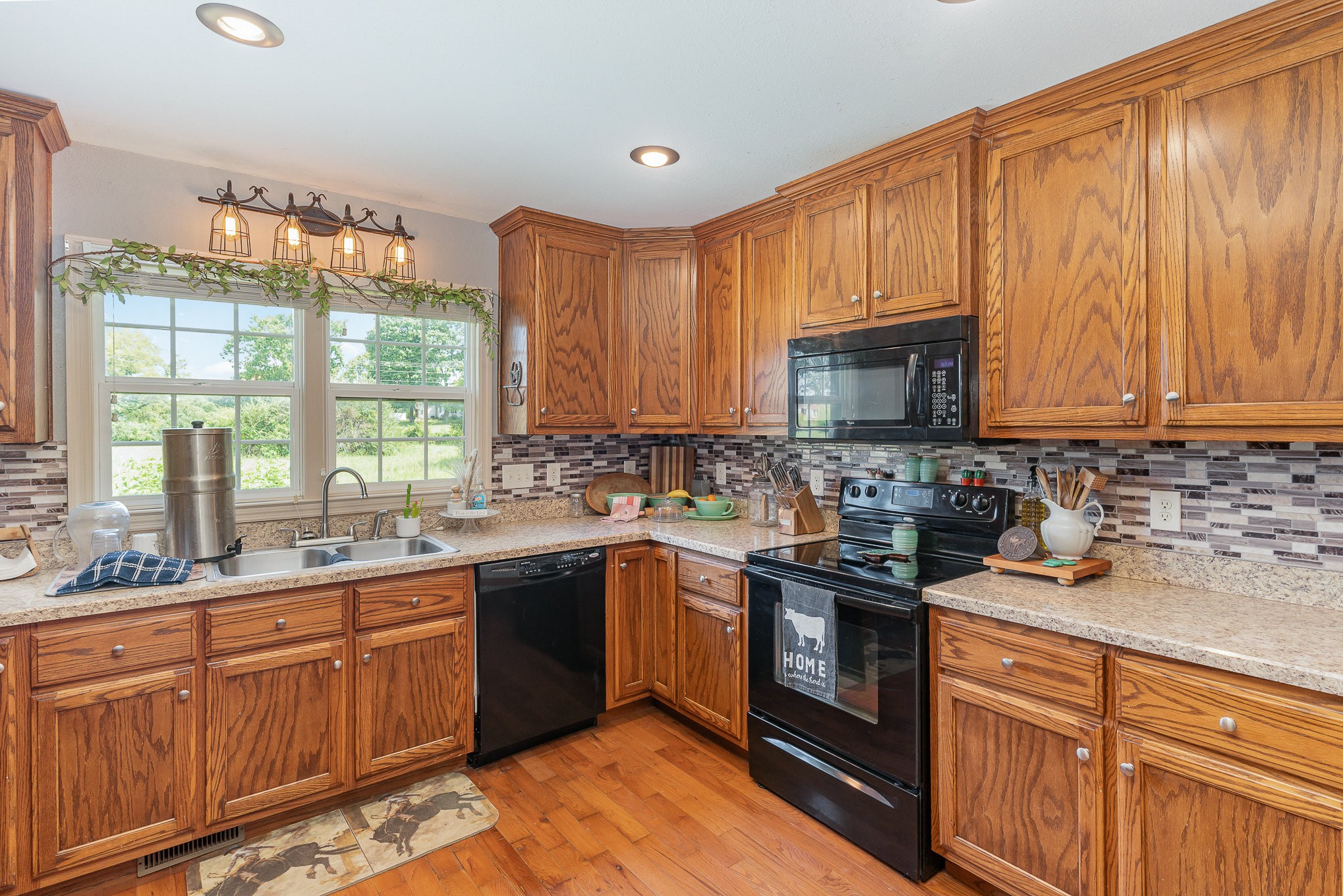 10919 Owens Chapel Road Springfield, TN 37172 - Photo 8 of 23 a kitchen with stainless steel appliances granite countertop wooden cabinets a sink and a stove