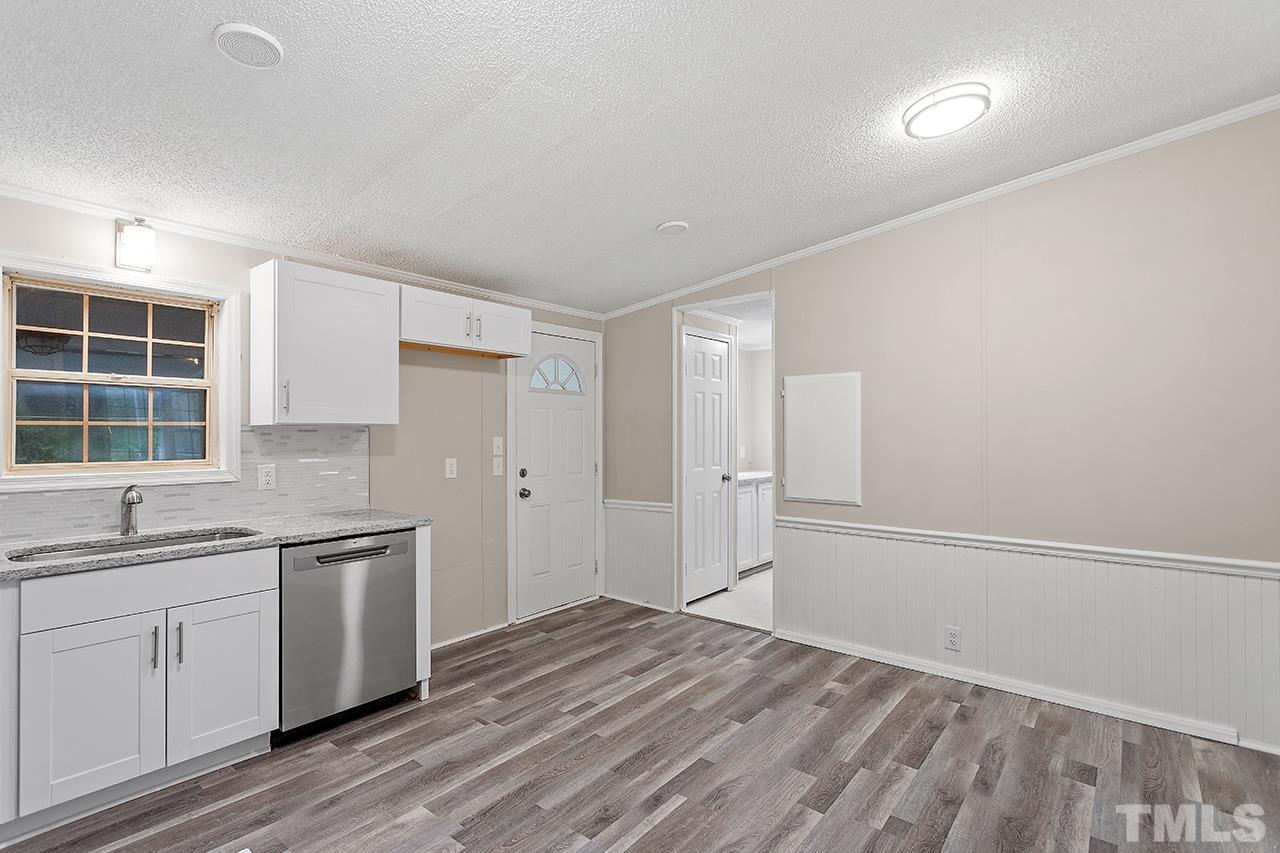 1002 Autry Road Lillington, NC 27546 - Photo 12 of 38 a view of a kitchen with wooden floor and electronic appliances