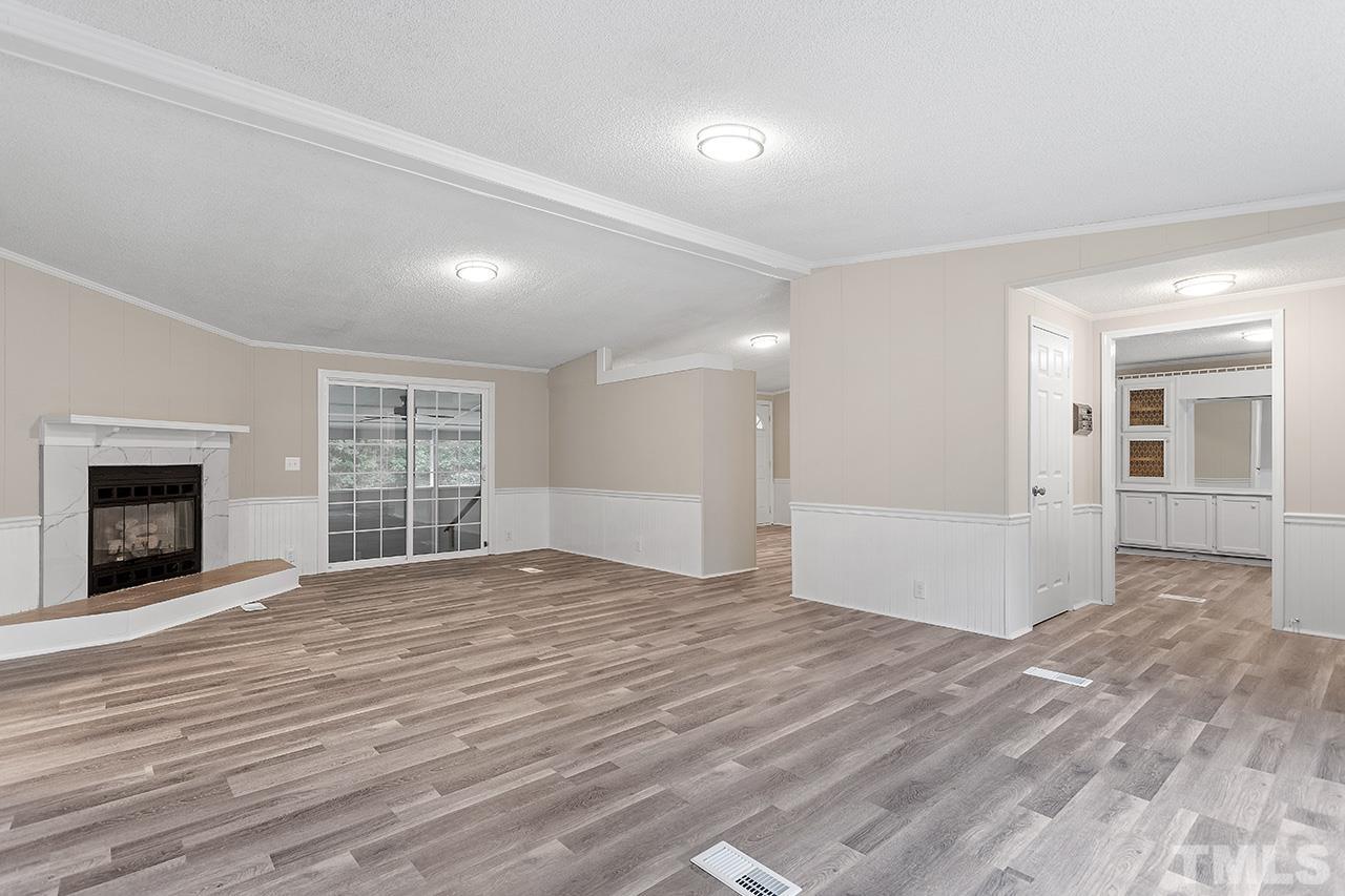 1002 Autry Road Lillington, NC 27546 - Photo 13 of 38 a view of an empty room with wooden floor and a window