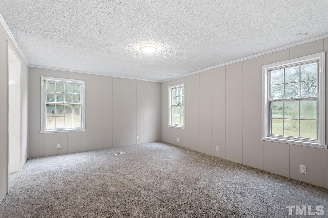 1002 Autry Road Lillington, NC 27546 - Photo 18 of 38 an empty room with windows