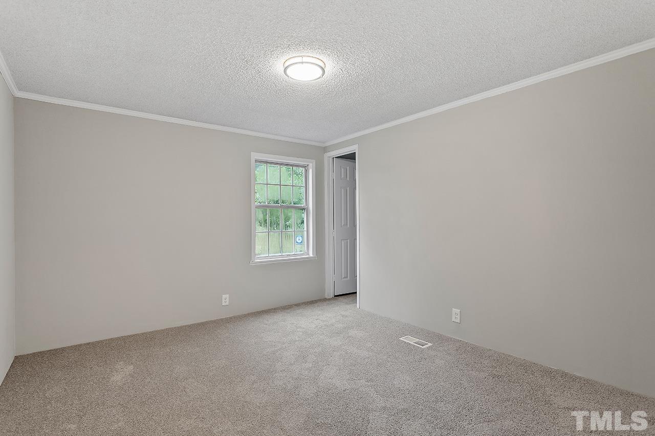 1002 Autry Road Lillington, NC 27546 - Photo 19 of 38 an empty room with windows